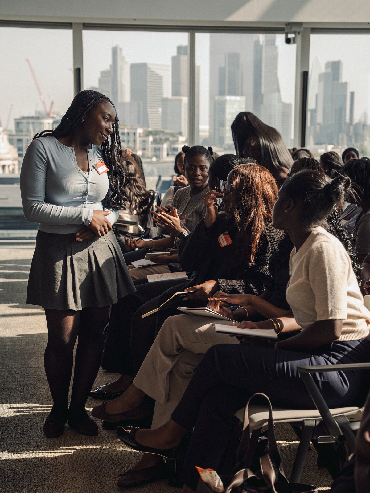 Attendees at work in front of the City skyline